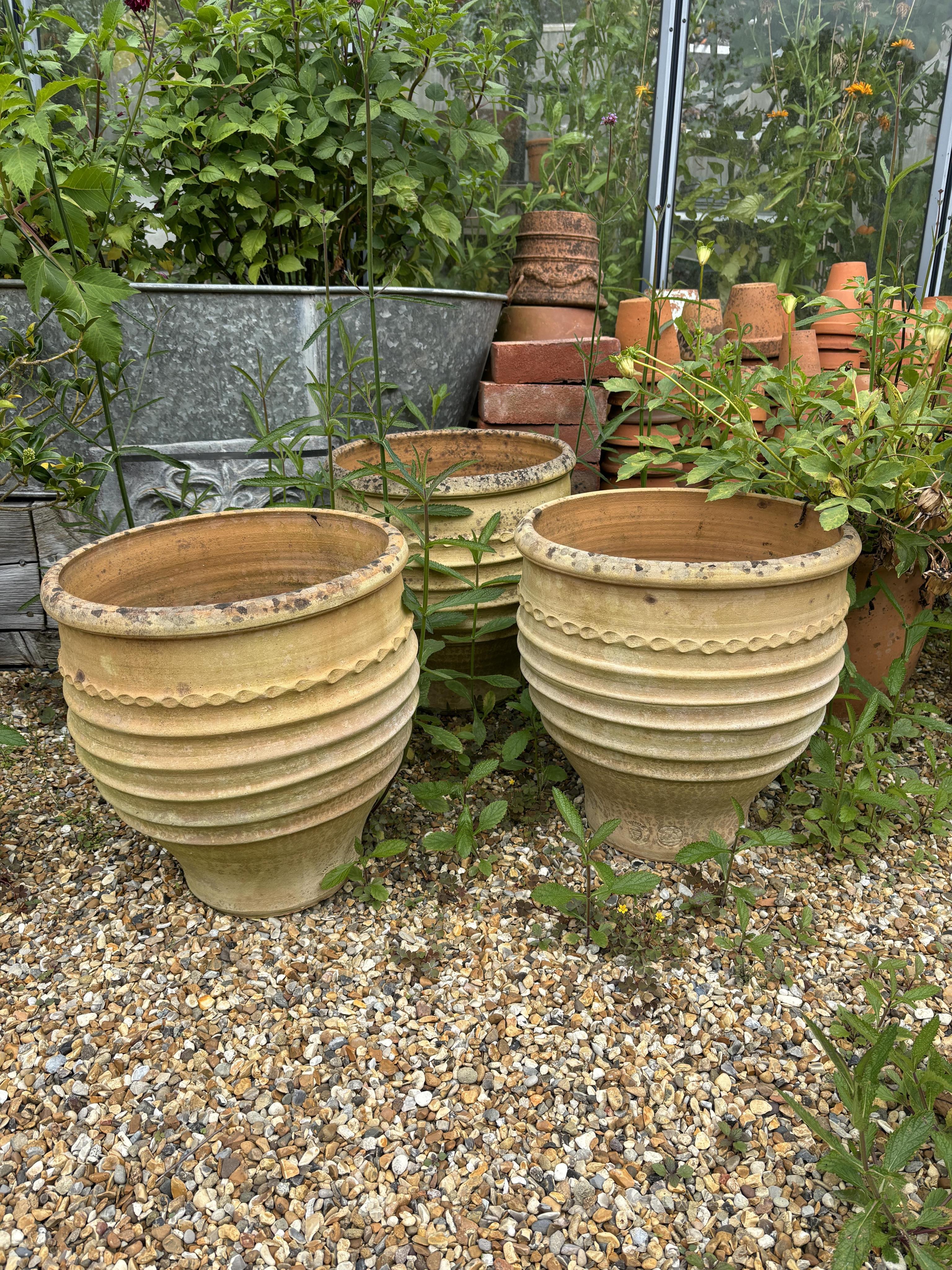 A set of four Minos Italian style terracotta planters, height 35cm, depth 40cm, and a pair of similar planters, planting removed. Condition - weathered, otherwise good